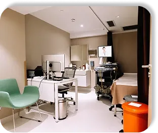 A consulting room with an ultrasound beside the bed