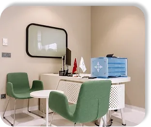A consulting desk with two green chairs