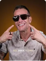 A man in sunglasses pointing at his new smile