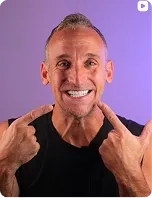 A patient pointing at his smile, on purple